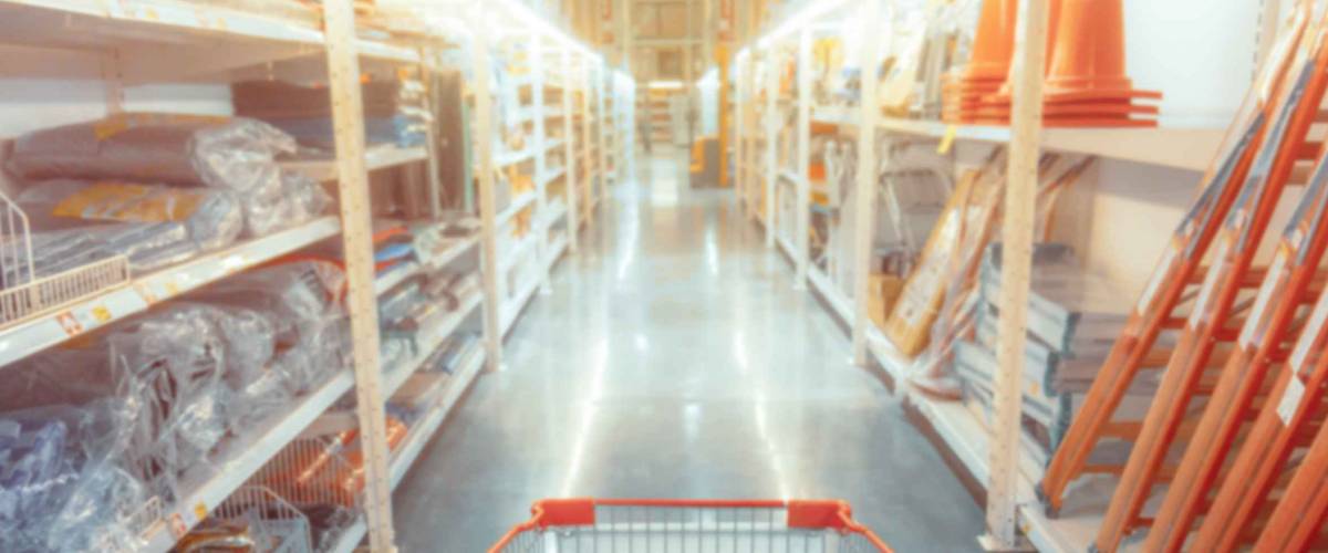 Abstract blurred photo of hardware store with empty shopping cart.