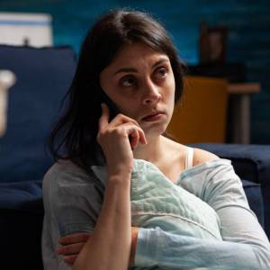 A woman worries about credit-card bills.