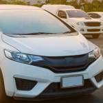 Cars parked in outdoor parking lot at a park in the evening time with  sunlight of sunset and beautiful orange sky background