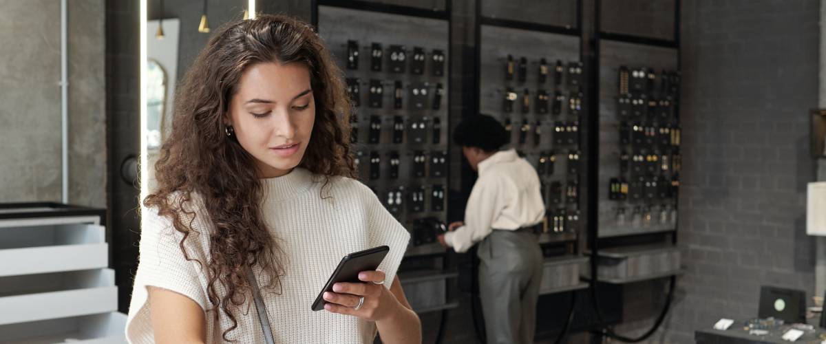 Young brunette female consumer getting a phone call