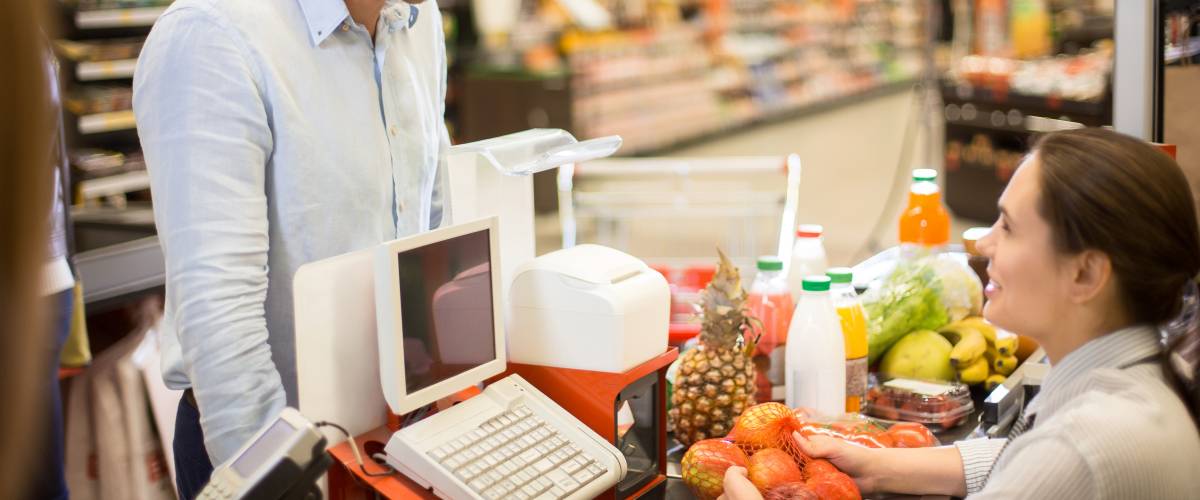 Customer Smiling to Cashier in Supermarket