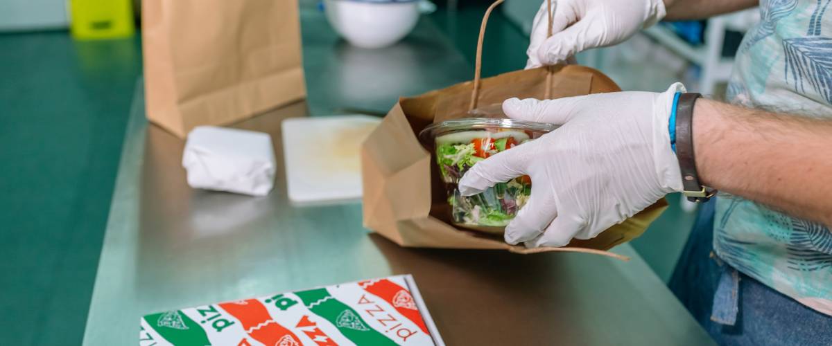 cook packing a takeaway order