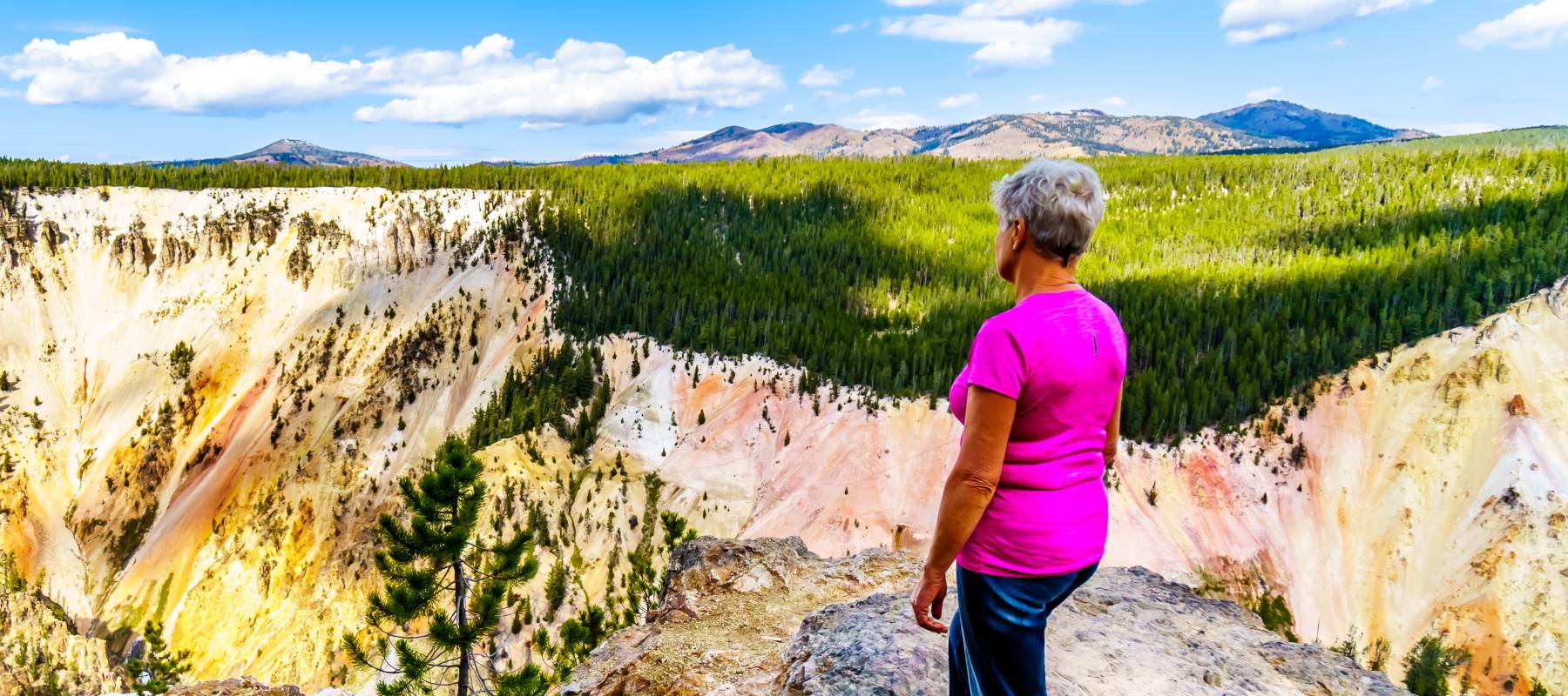 An older woman hiking at the North Rim of the Grand Canyon in Wyoming, ranked the best state to retire in 2026.