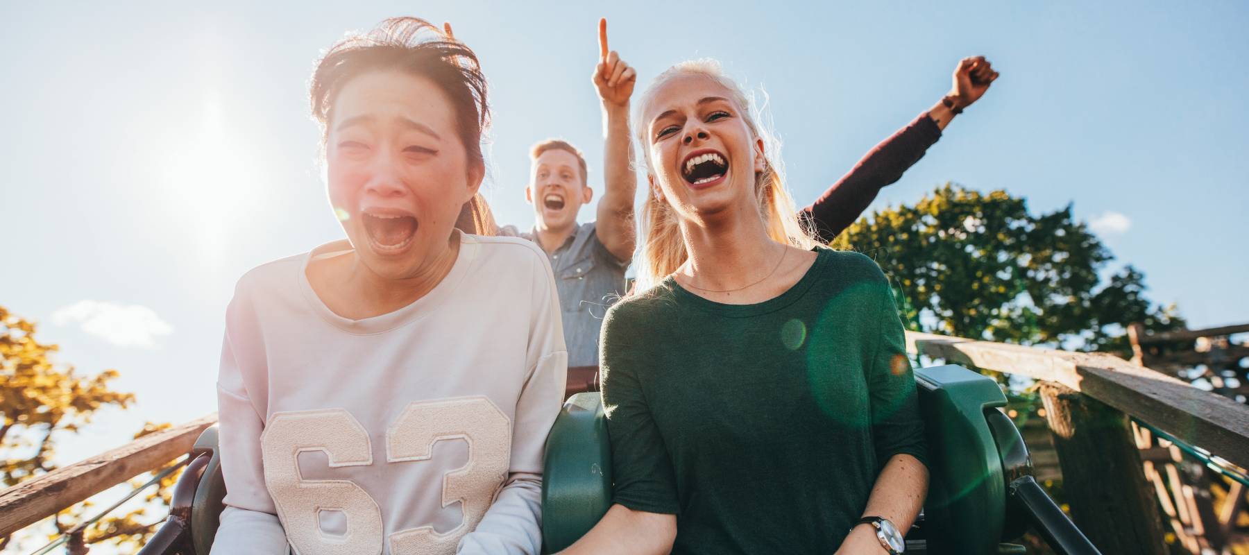 One person having fun and one person scared on a roller coaster representing precious metal prices.
