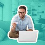 Happy cheerful man smiling while e-shopping