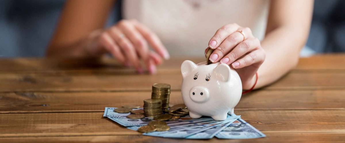 The bride counts the money. Wedding expenses. Bride with a piggy bank