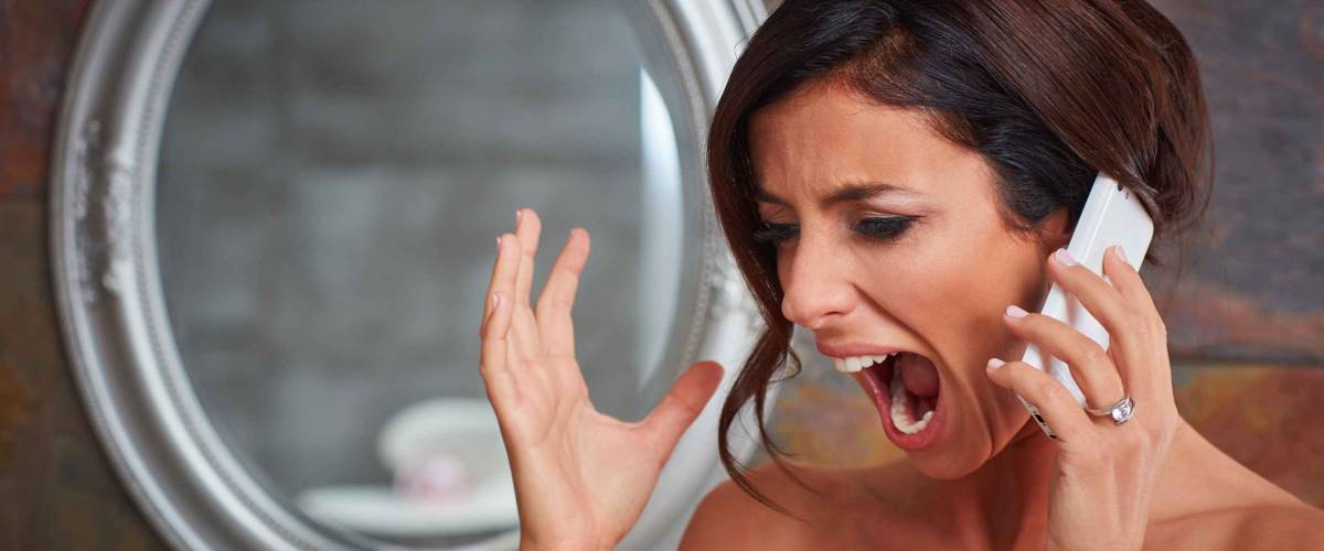 Closeup photo of young bride shouting on mobilephone.