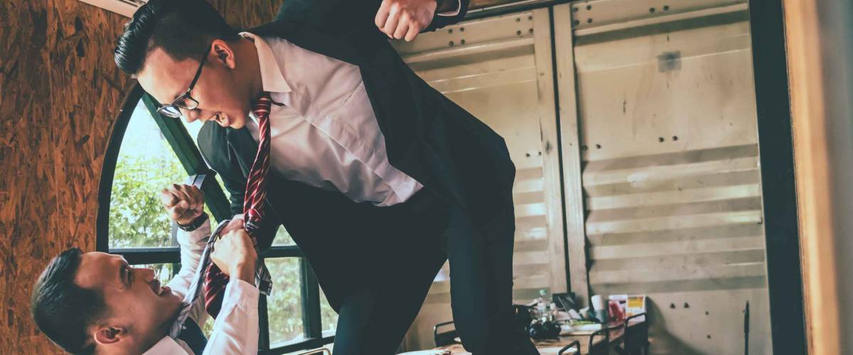 Businessman fighting with his coworker in office.