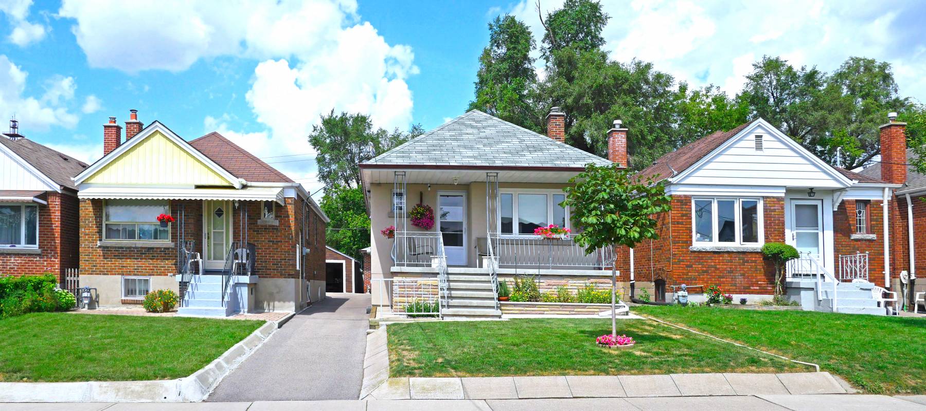 Street with row of modest 1950s style working class bungalows
