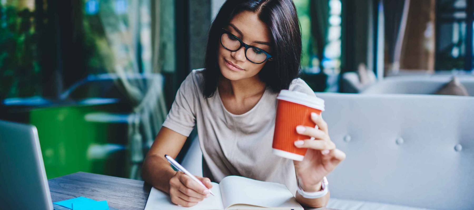 Concentrated female student writing in notebook.