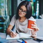 Concentrated female student writing in notebook.