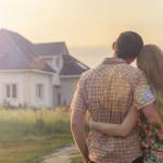 rear view of young couple looking at their new house