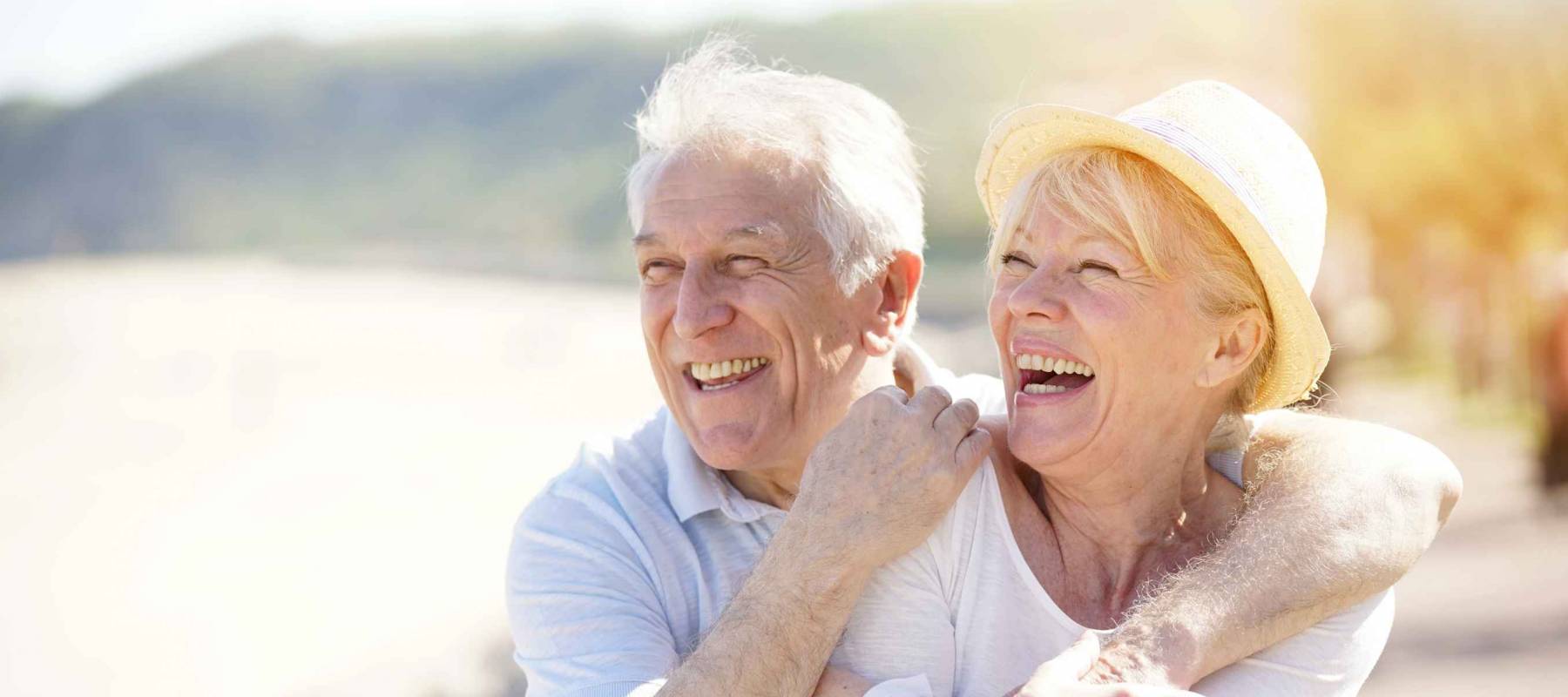 Senior couple relaxing by the sea on sunny day