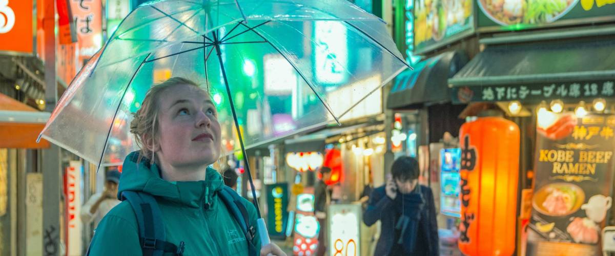 Girl standing under umbrella in Tokyo, Japan