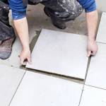 Tiling Floor &amp; Wall. The tiler builder arranges the bathroom ceramics.