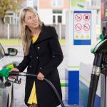 Woman refilling car with fuel