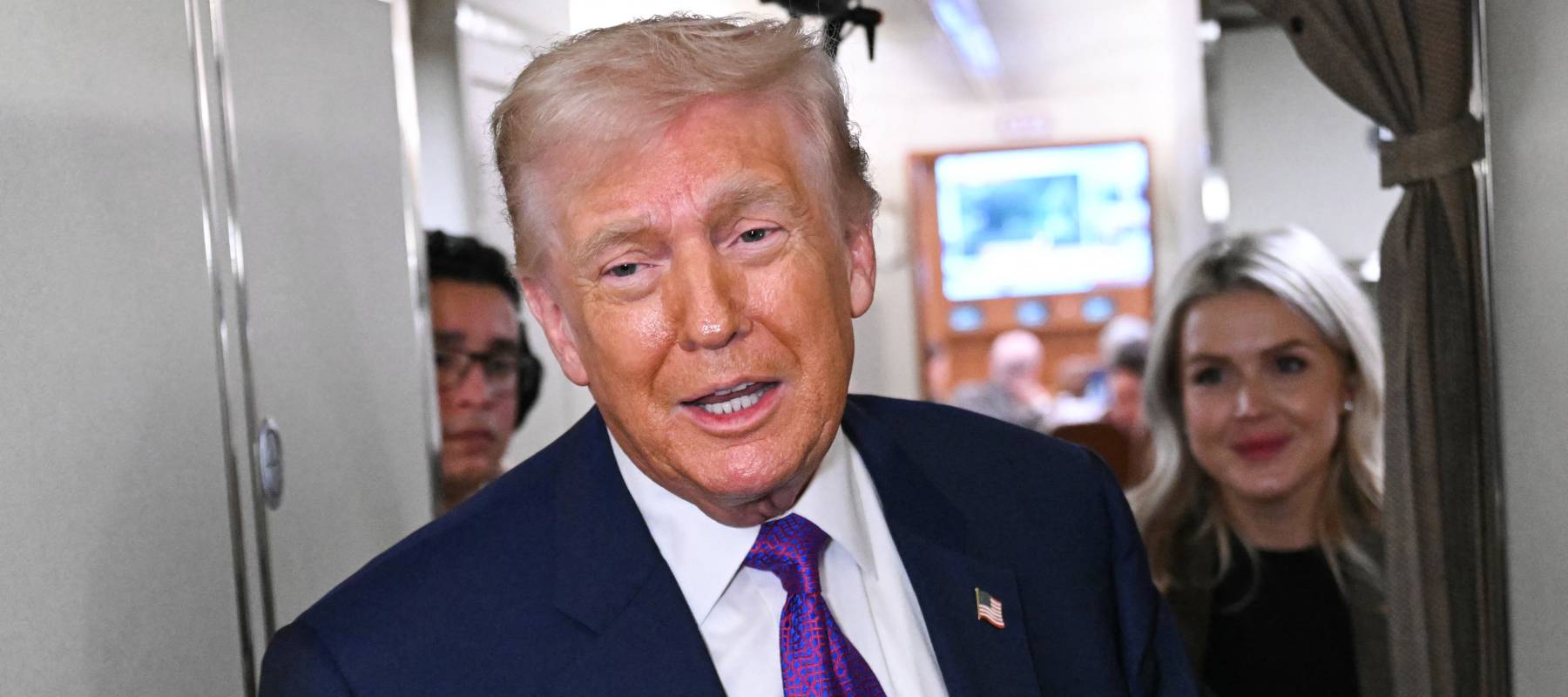 US President Donald Trump speaks to reporters on Air Force One before taking off.