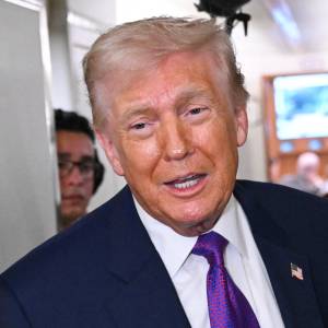 US President Donald Trump speaks to reporters on Air Force One before taking off.