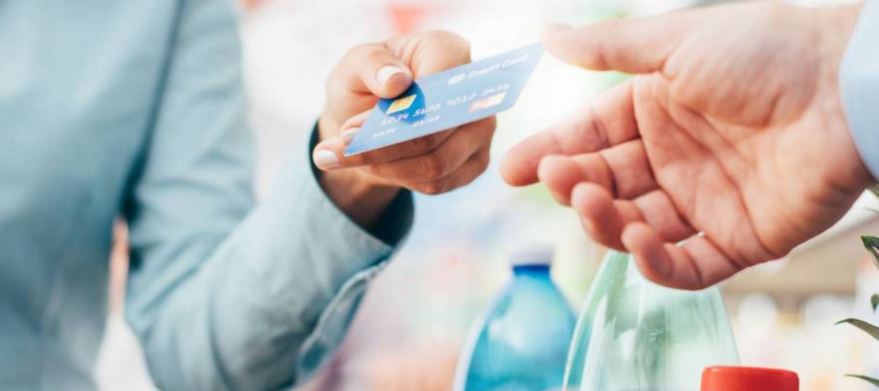 Paying with a credit card at grocery store checkout