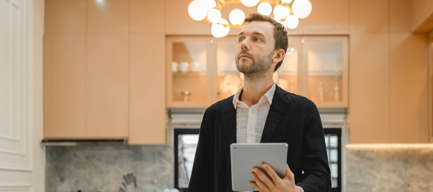 Person holding a tablet and exploring a prospective real estate investment.