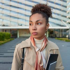 A woman walking away from an office building could be one of many workers navigating a workplace where job loyalty no longer guarantees financial security.