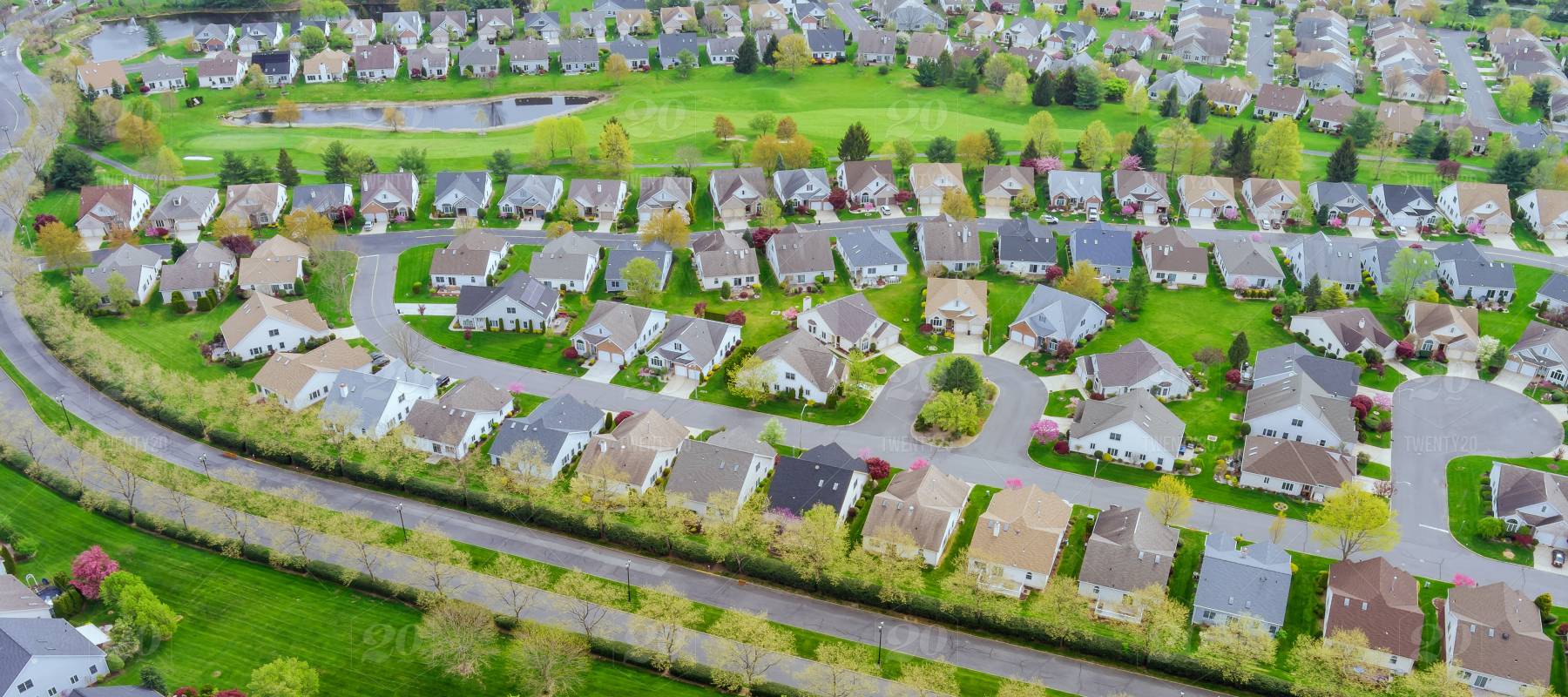 Small American town district with houses and roads on aerial view landscape