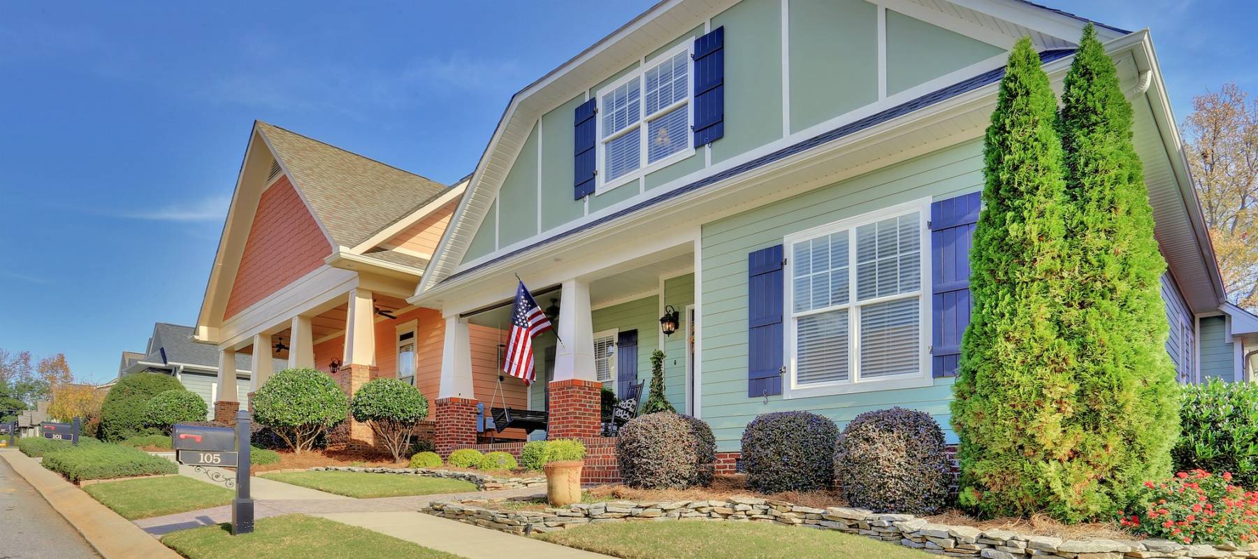 Teal town home surrounded with beautiful blue skies.