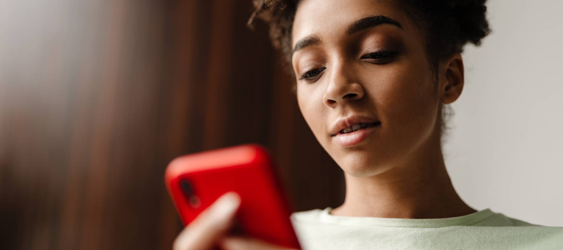 A woman checking her smartphone as cash-advance apps make  it increasingly easier for users to borrow against their paychecks.