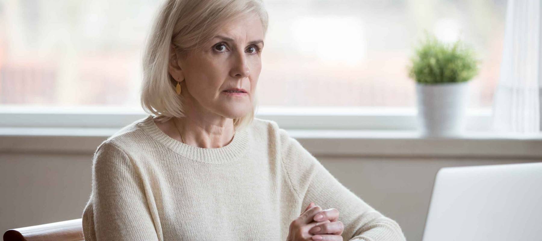 Thoughtful serious mature senior woman thinking of problem.