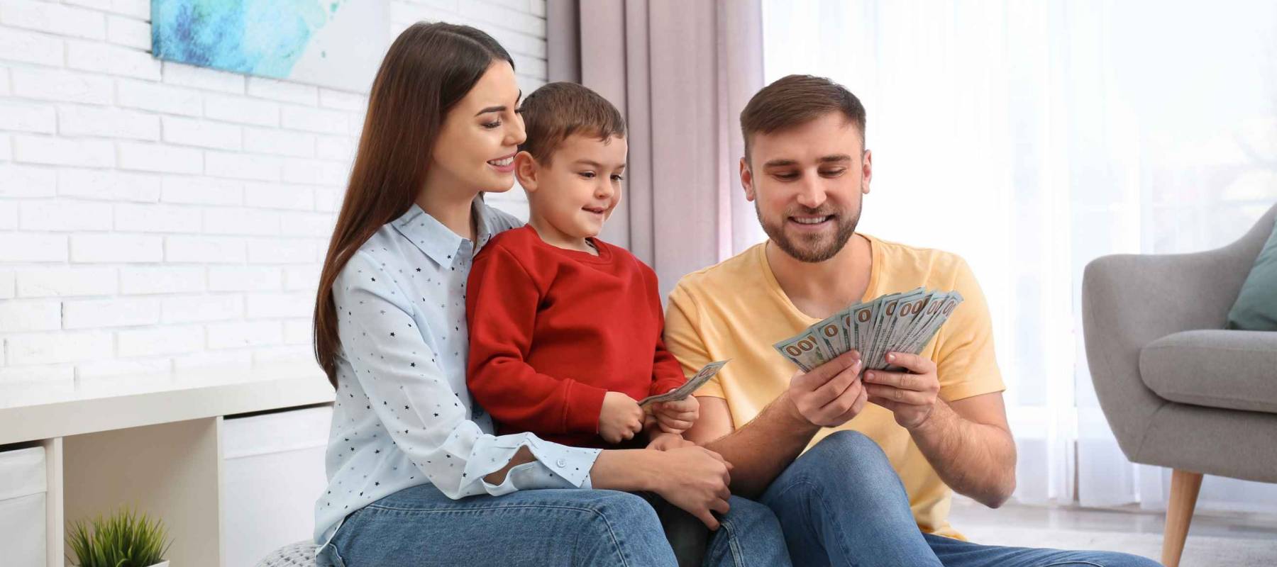 Happy family with money at home. Financial planning