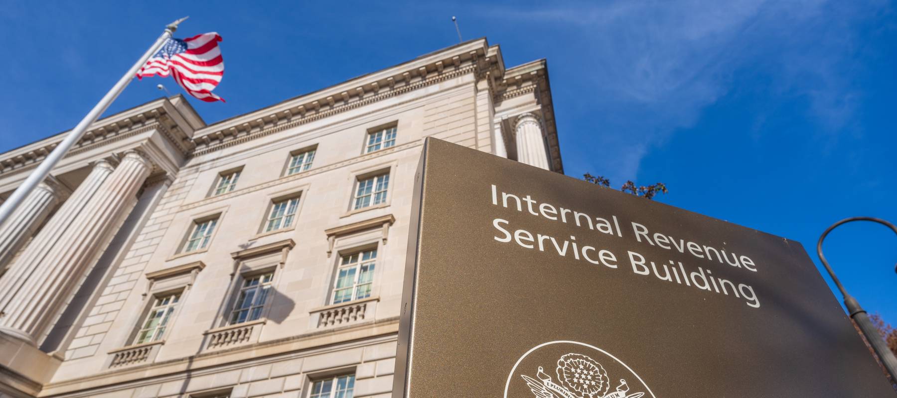 An American flag flies above the International Revenue Service headquarters building.