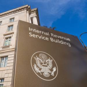An American flag flies above the International Revenue Service headquarters building.
