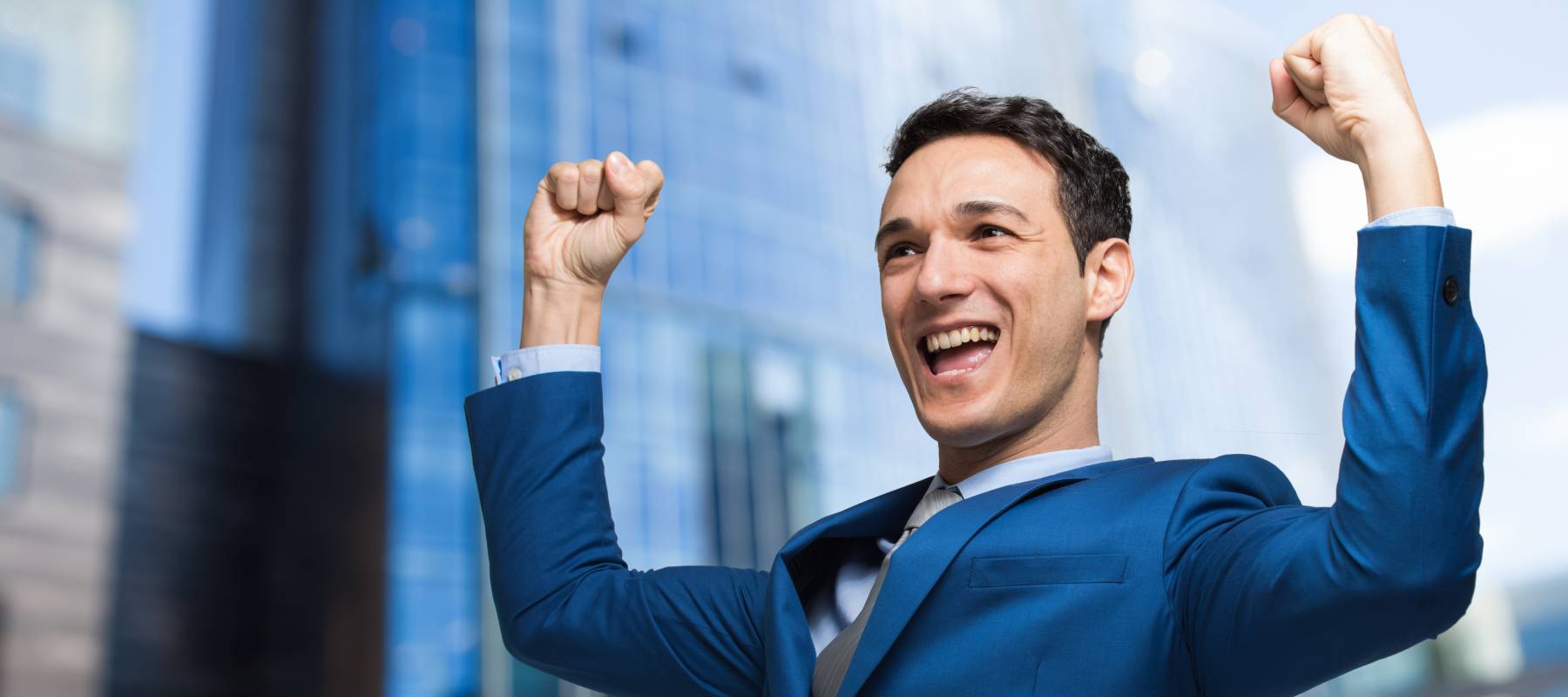 Happy man with raised arms.