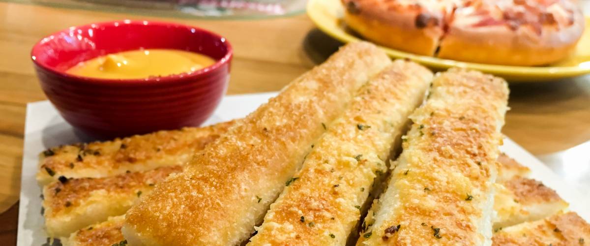 Plate of breadsticks with dipping sauce