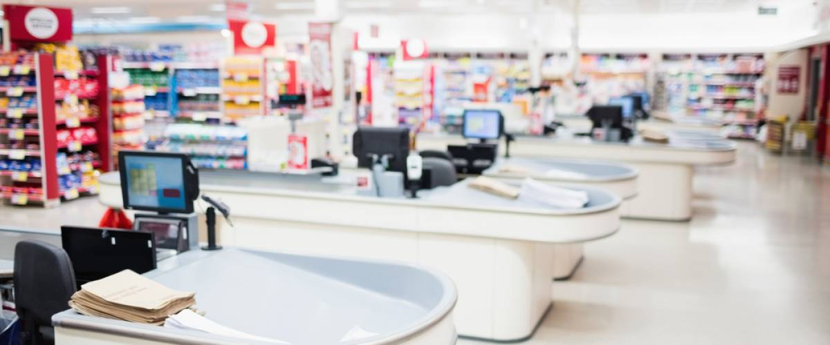 View of tills and aisles at grocery store