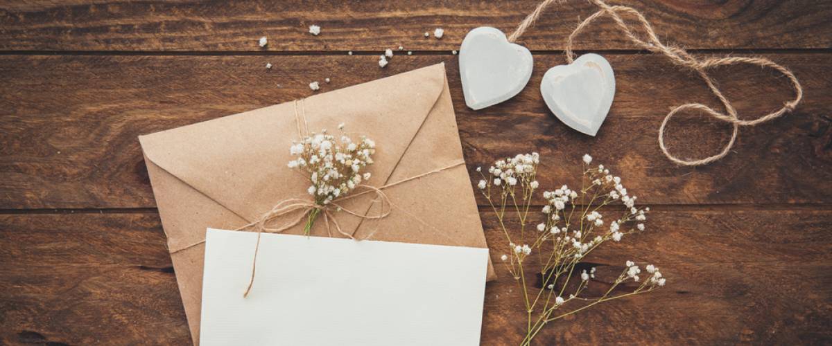 Brown and white craft supplies for wedding displayed on table