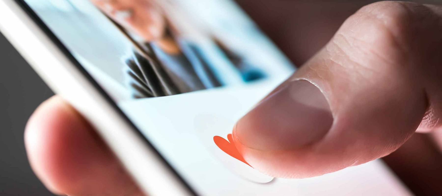 Man giving a like to photo on social media or swiping on online dating app.