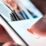 Man giving a like to photo on social media or swiping on online dating app.