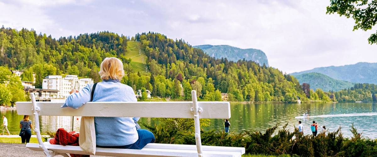 Woman sitting on the bench at Bled Lake, Slovenia