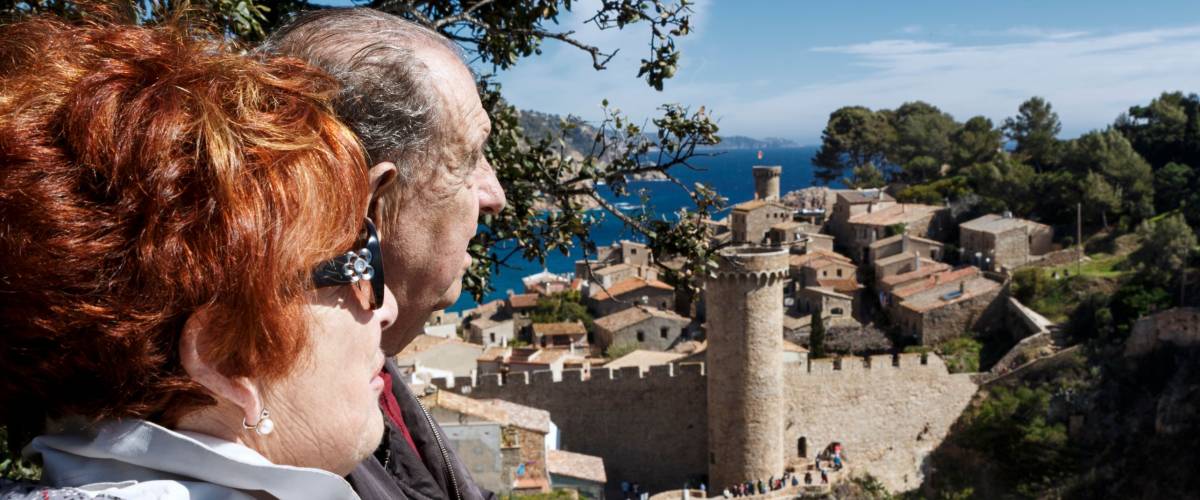 Retired couple on vacation visiting Tossa de Mar. Spain