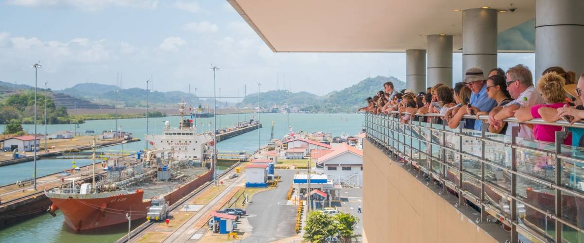 Panama City, Panama - march 2018: Group of tourist people at viepoint balustrade looking at Panama Canal, Miraflores Locks, Panama City