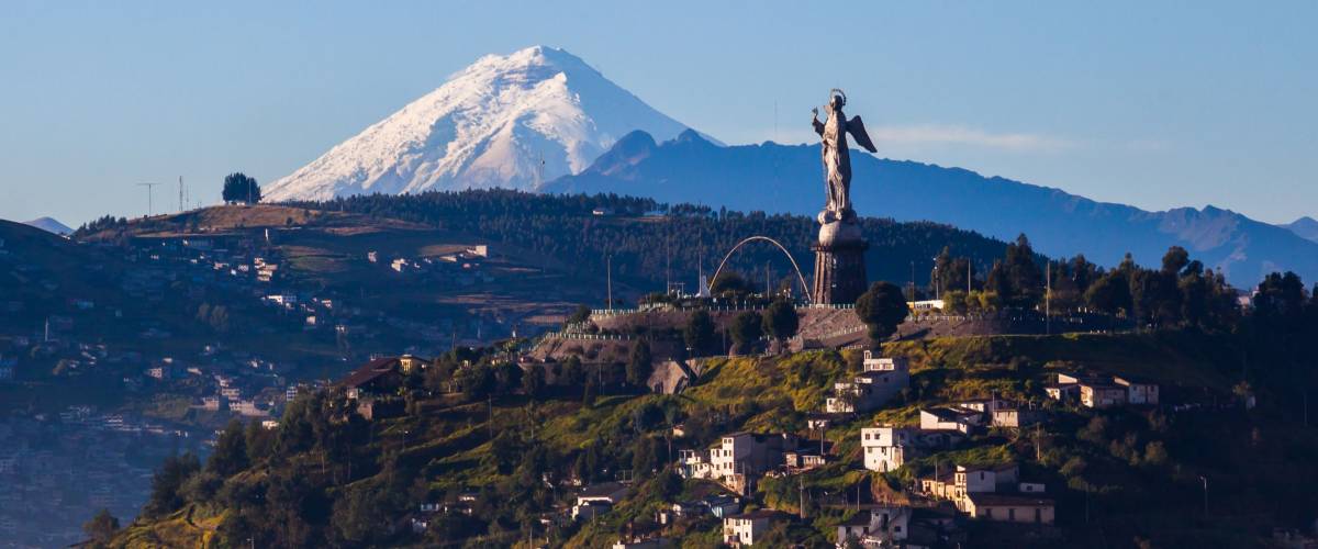 View of El Panecillo in the center of Quito with the Cotopaxi in the background