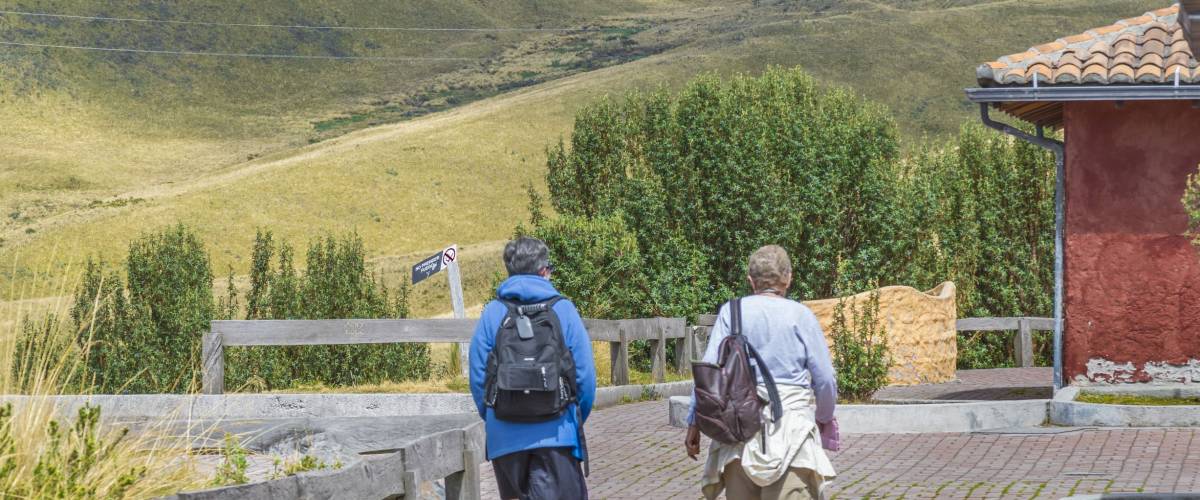 QUITO, ECUADOR, OCTOBER - 2015 - Back view of two elderly women walking on nature in a tour in the highs of Quito, Ecuador