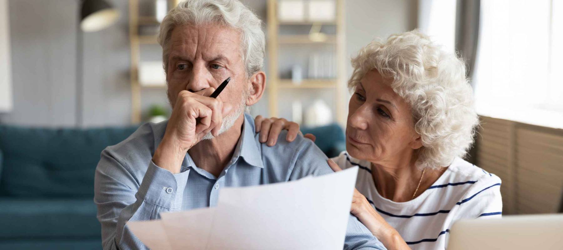 Compassionate elderly woman supporting upset stressed mature husband