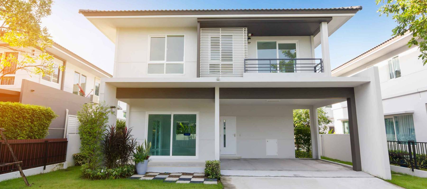 Beautiful exterior of newly home with green grass and blue sky during at sunrise.Front View of New Residential house for sale.Home For Sale,Rent,Housing and Real Estate concept.