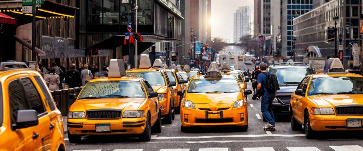 Yellow Taxi in Manhattan, New York City  in USA sunset