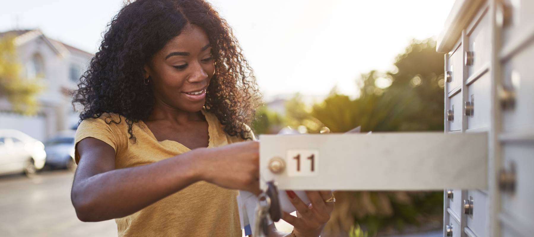 A woman checks her mailbox
