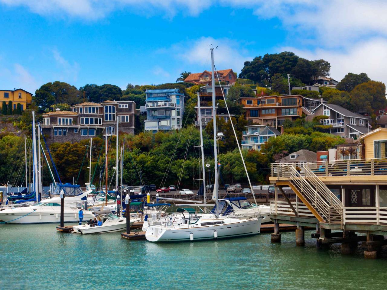 Yacht harbor and waterfront in Tiburon, CA.  View from the water of boats and hillside homes.  Tiburon is an affluent suburb of San Francisco on the bay.