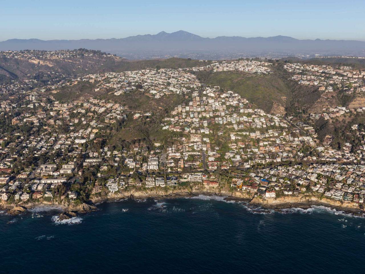 Aerial of hillside ocean view homes in the Laguna Beach neighborhood of Orange County, California.