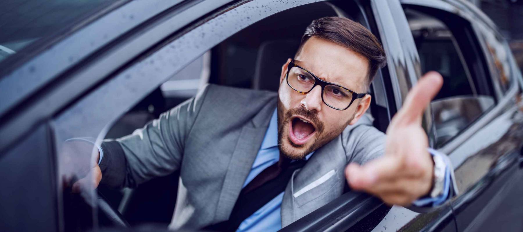 A sharp dressed man finding himself caught in a rush hour and slowly succumbing to road rage.